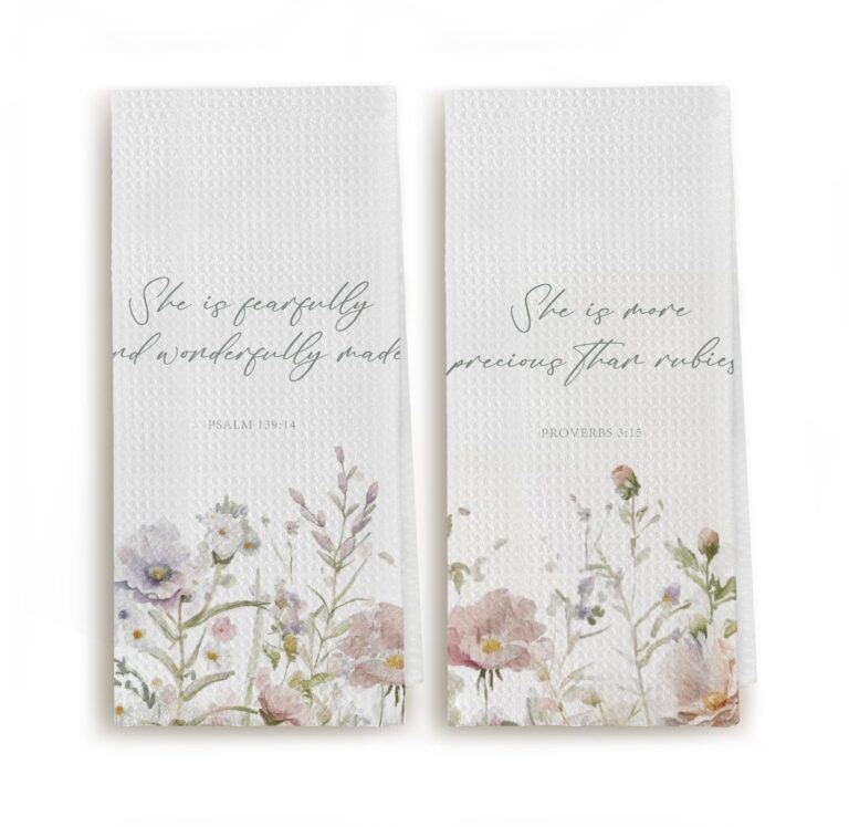 Two white towels with floral designs and inspirational quotes