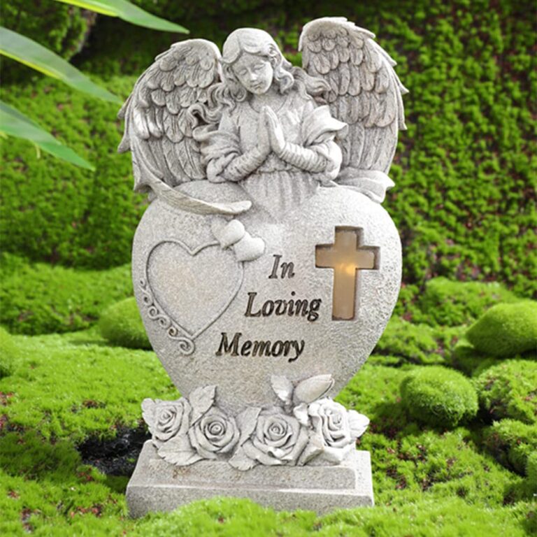 Angel statue with heart, cross, and "In Loving Memory" on moss