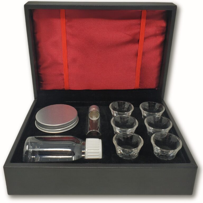 Open black box with glass vials, cups, and a silver lid