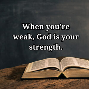 Open bible on a wooden table with an inspirational quote about strength